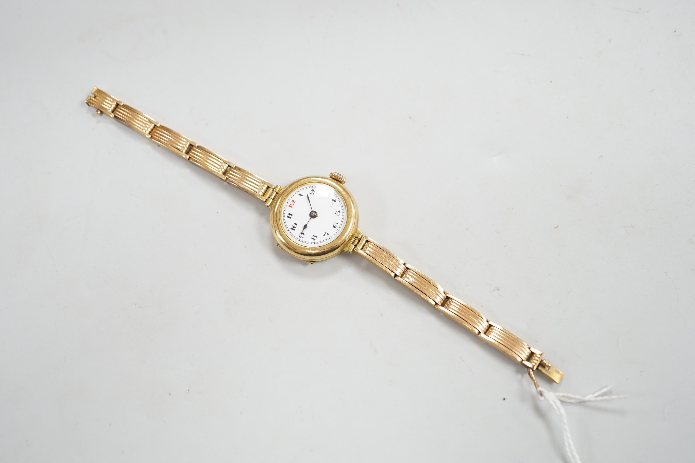 An early 20th century 18ct gold manual wind wrist watch, on an 18ct flexible bracelet, case diameter 25mm, gross weight 25.9 grams.